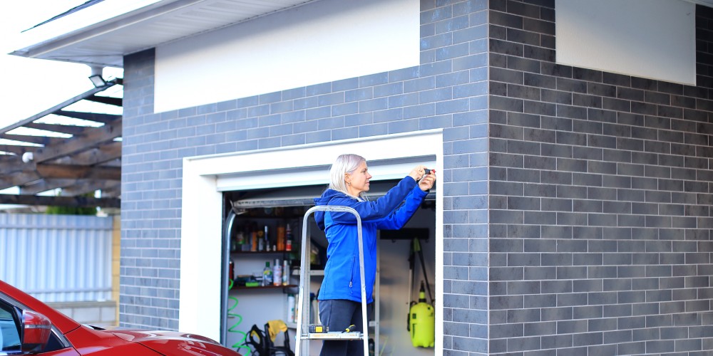 Lady adjusting garage door