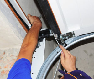 Man adjusting a garage door track